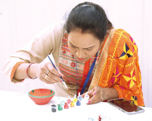 A participant during the diya-painting competition - Candor TechSpace